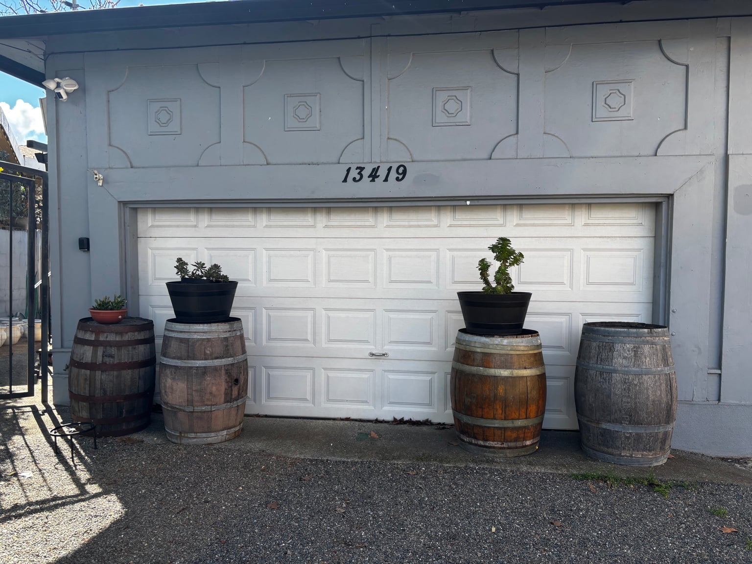 13419 garage with plain wine barrels and a single potted succulent — before
